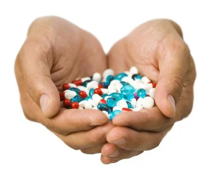 Hands holding pills Stock Photos