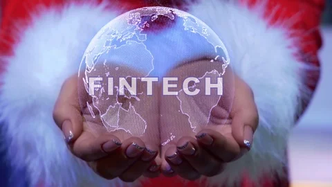 Hands holding planet with text Fintech Stock Footage 124738701