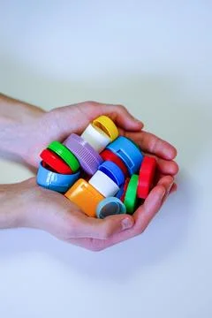 Hands Holding Plastic Bottle Caps Stock Photos