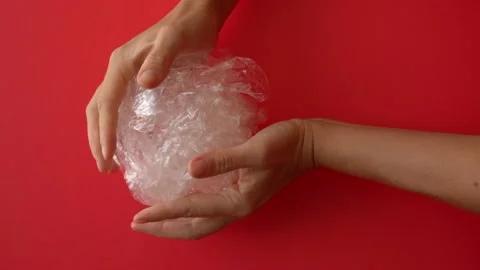 Hands holding plastic waste on the red background Vídeos de archivo 147371580