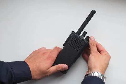 Hands holding a portable walkie-talkie Stock Photos