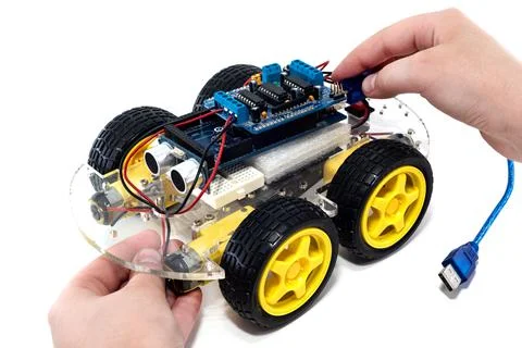 Hands holding programmable robotic car Foto stock