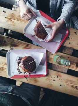 Hands holding pulled pork burger Stock Photos