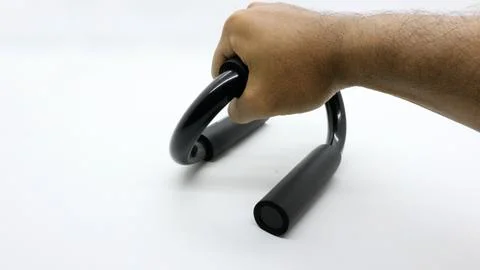 Hands holding a push up bar for exercise on a white background Stock Photos