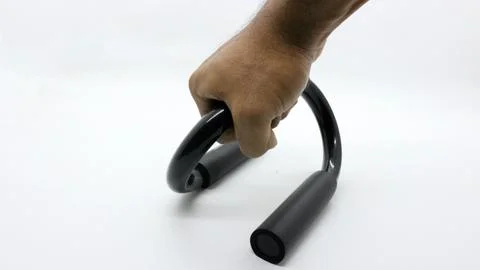 Hands holding a push up bar for exercise on a white background Foto stock