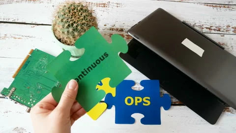 Hands holding puzzle with Continuous and Integration words near laptop Stock Footage 123145633