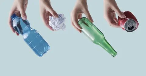 Hands Holding Recyclable Materials Plastic Glass Paper and Metal Waste Concep 스톡 사진