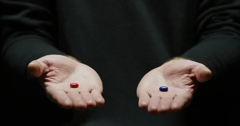 Hands holding a red and a blue pill Stock Footage