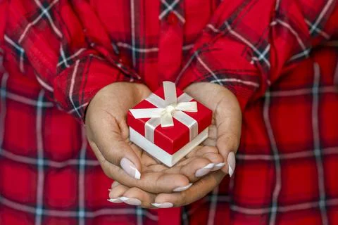 Hands holding red gift box Stock Photos