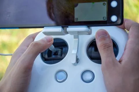 Hands Holding Remote Controller for Drone Flight with Display Screen 库存照片