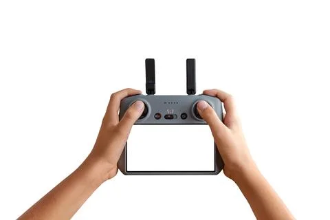 Hands holding a remote drone controller with empty screen, ideal for insert.. Stock Photos