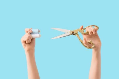 Hands holding sewing scissors and thread spools for tailoring and crafting pr Stock Photos