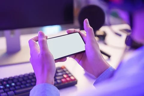 Hands holding smartphone with blank screen for mobile game mockup Stock Photos
