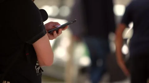Hands holding a smartphone inside the terminal at modern airport. Stock Footage 311423687