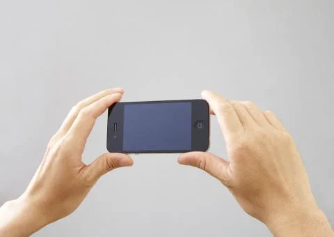 Hands holding a smartphone Stock Photos