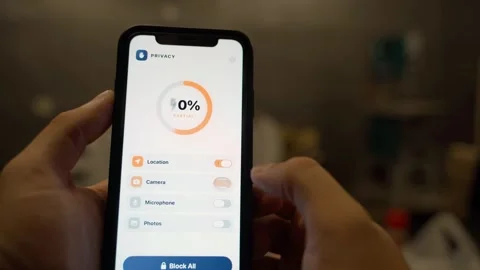 Hands holding smartphone with privacy settings app showing app permissions Stock Footage 341746363