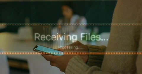 Hands holding smartphone with processing text animation over blurred background Stock Footage 328595521