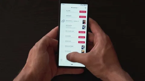 Hands holding smartphone scrolling through TikTok Feed and social media Video stock 139333957