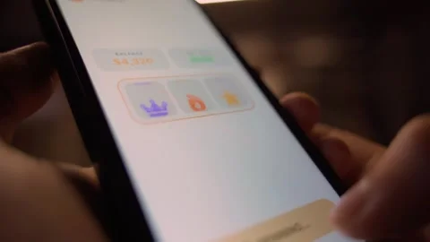 Hands holding smartphone with slot machine app showing jackpot win close-up Stock-Footage 341746360