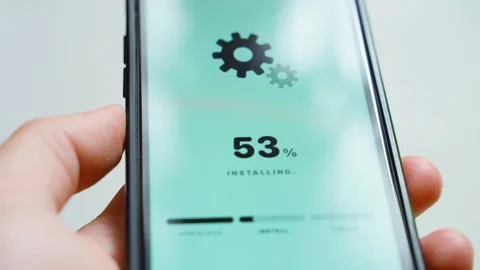 Hands holding smartphone with software update downloading at percent close-up Stock Footage 342129462