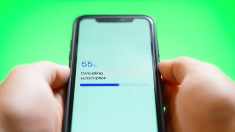 Hands holding smartphone with subscription cancellation progress and 스톡 동영상 342129827