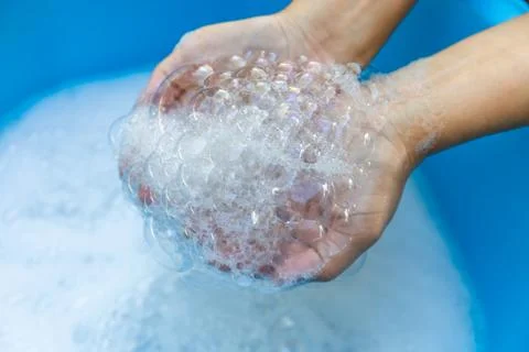 Hands Holding Soap Bubbles in Clean Water, Close-up, Wash hands hygiene Stock Photos