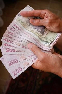 Hands holding stack of Turkish lira banknotes, finance and economy concept 스톡 사진