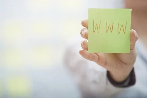 Hands holding sticky note with internet address Stock Photos