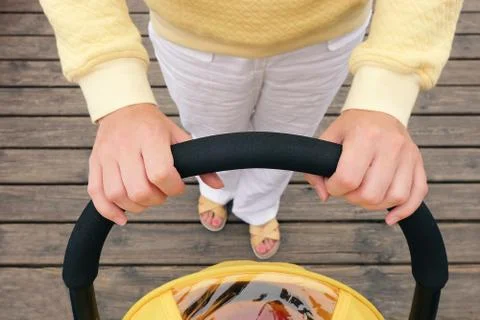 Hands holding stroller handle Stock Photos