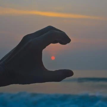 Hands holding the sun 2 Stock Photos