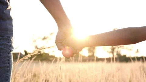 Hands Holding with Sunlight Between Mother and Child Vídeos de archivo 314303454