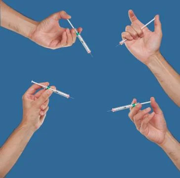 Hands holding syringes Stock Photos