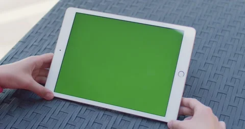 Hands holding tablet with green screen mockup for digital content presentation Stock Footage 345448223