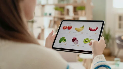 Hands holding tablet pc and scrolling web page of grocery store. Use online paym Stock Footage 199484700