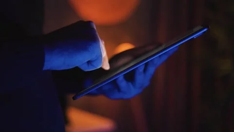 Hands Holding Tablet Screen in Dark Room Video stock 346809953