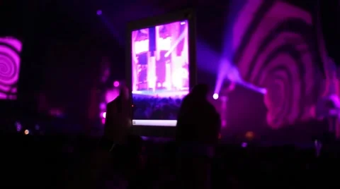 Hands holding tablet, which shooting central scene among crowd Video stock 63661363