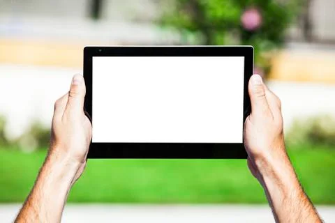 Hands holding tablet with white screen. Stock Photos