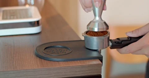 Hands holding tamper coffee pressed into the horn holder. Stock Footage 223209749