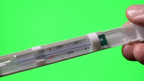 Hands holding thermometer on green screen background Stock Footage 129465675