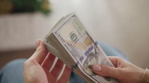 Hands holding thick stack of dollar bills Stock Footage 330888063