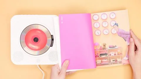 Hands holding Twice Between 1 and 2 mini Album photobook on yellow. Music CD  Stock Photos
