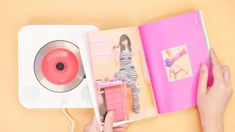 Hands holding Twice Between 1 and 2 mini Album photobook on yellow. Music CD  Stock Photos