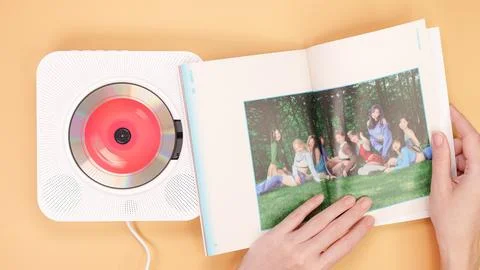 Hands holding Twice Between 1 and 2 mini Album photobook on yellow. Music CD Stock Photos