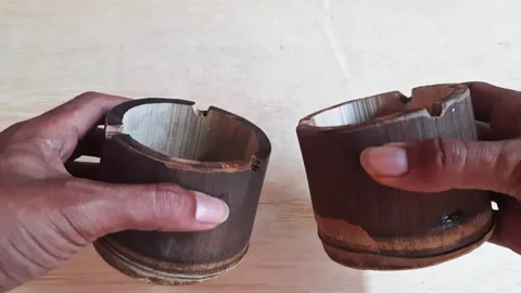 Hands holding two bamboo ashtrays showing craftsmanship and sustainability Stock Footage 322758600