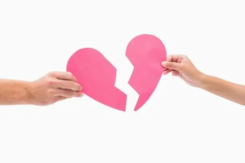 Hands holding two halves of broken heart Stock Photos