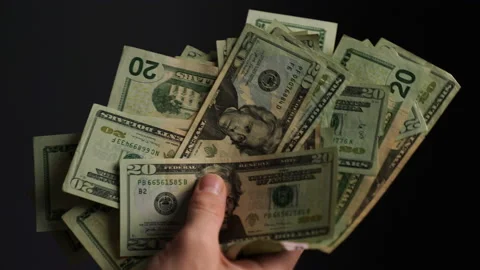 Hands holding us dollars in 4k. Stock Footage