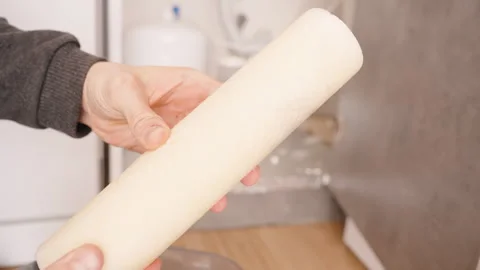 Hands Holding a Used Paper Filter from a Reverse Osmosis System, Preparing to Stock Footage 296574161