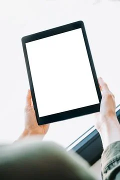 Hands Holding Vertical Tablet with Blank Screen Mockup Stock Photos