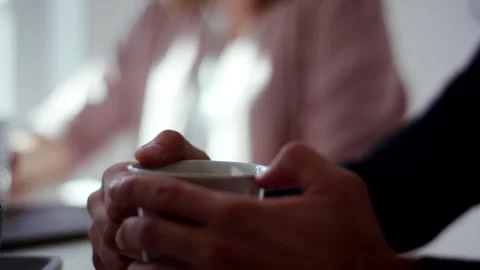 Hands Holding Warm Cup by Bright Window, Cozy Indoor Scene, Close Up Shot Stock Footage 341441700