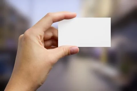 Hands holding a white business visit card, gift, ticket, pass, p 스톡 사진
